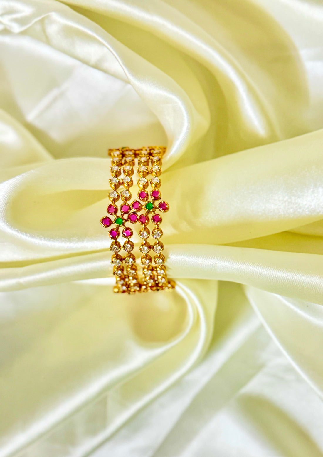 Golden Bangles with Pink Floral Accents and Dazzling Diamond Finish