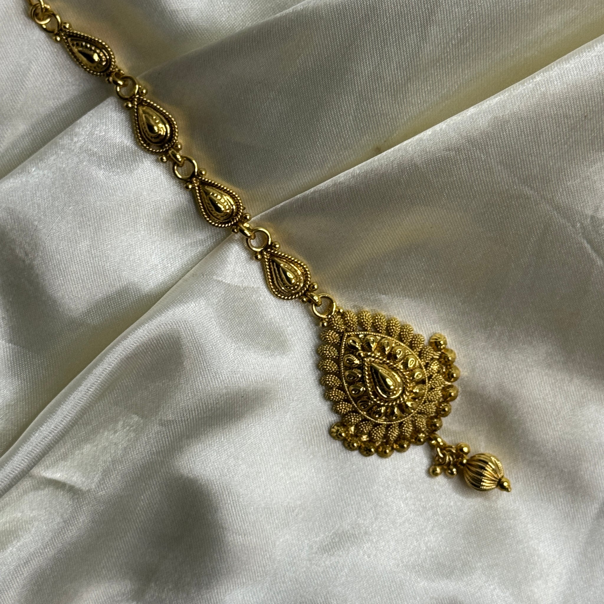 Golden Grace: Antique Maangtikka with Leaf Motif and Golden Bead