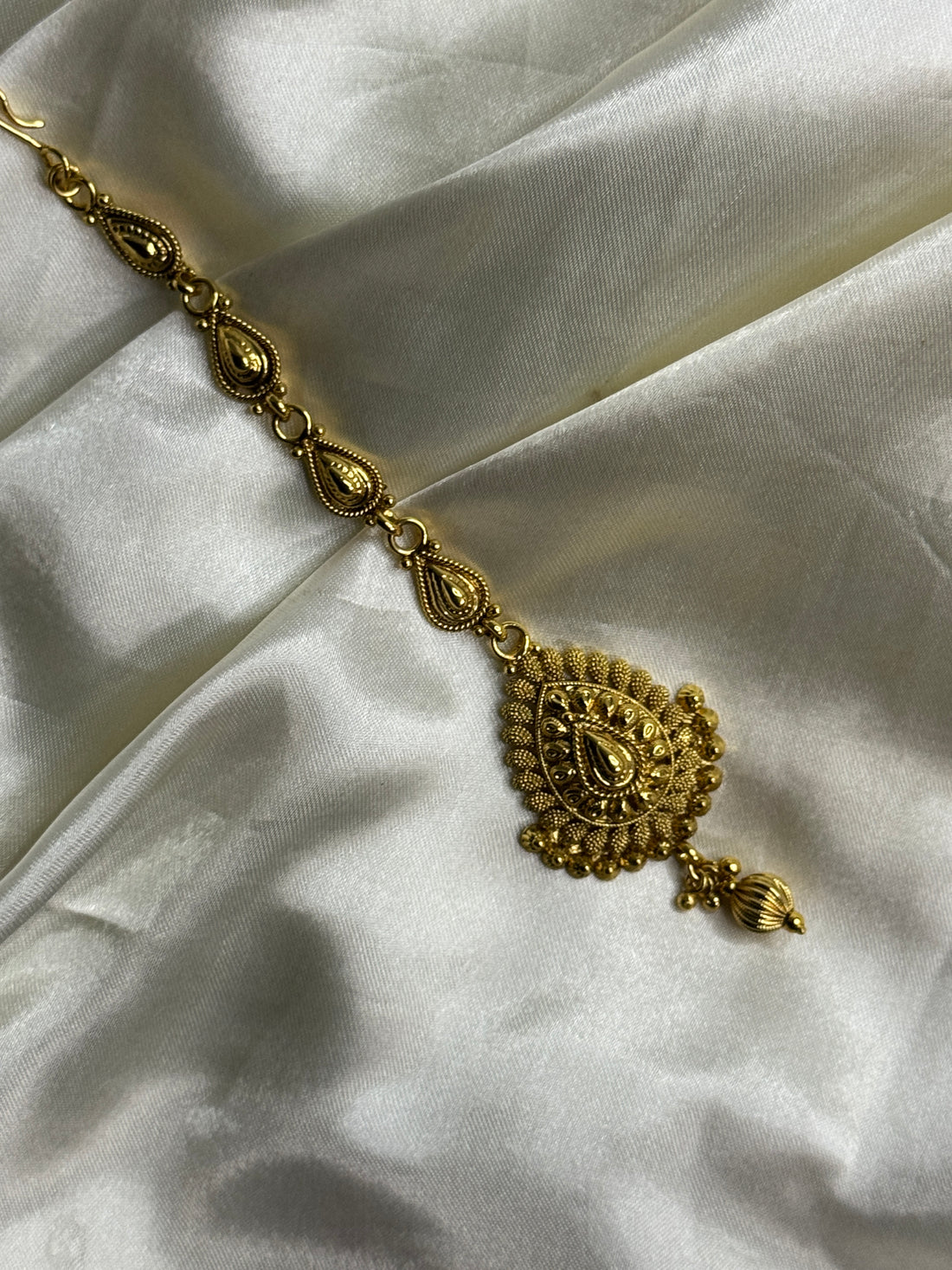 Golden Grace: Antique Maangtikka with Leaf Motif and Golden Bead