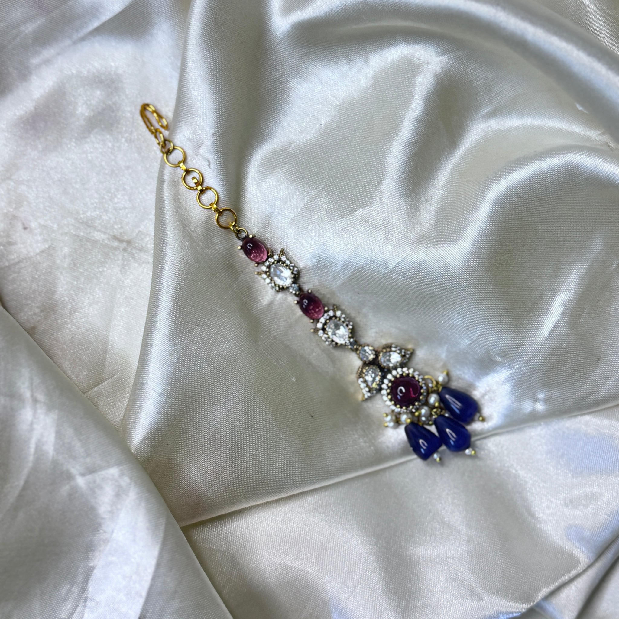 Enchanting Purple Stone Maangtikka with Floral & Leaf Accents