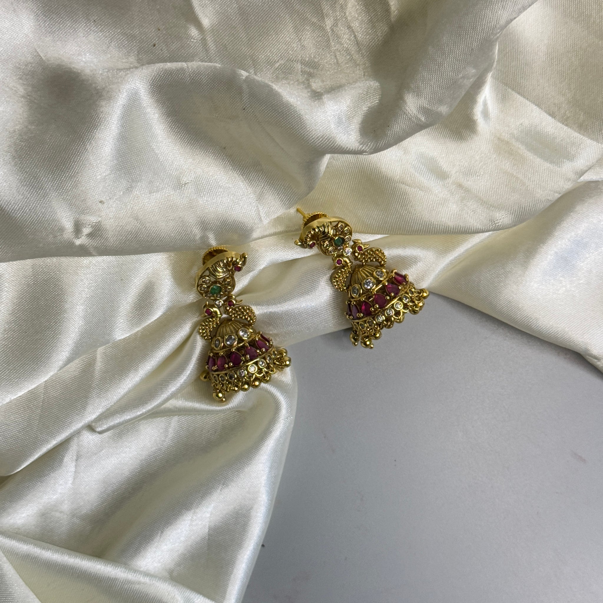 Majestic Jumka Earrings with Peacock Detailing, Red Stones & Crystal Finish